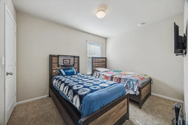 a bedroom with a bed and a television