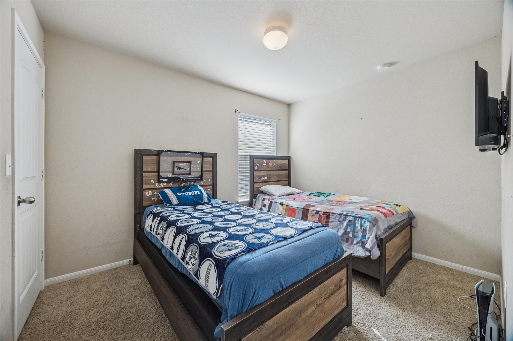 15211 Wideleaf Cove Austin, TX 78724 - Photo 12 of 15 a bedroom with a bed and a television