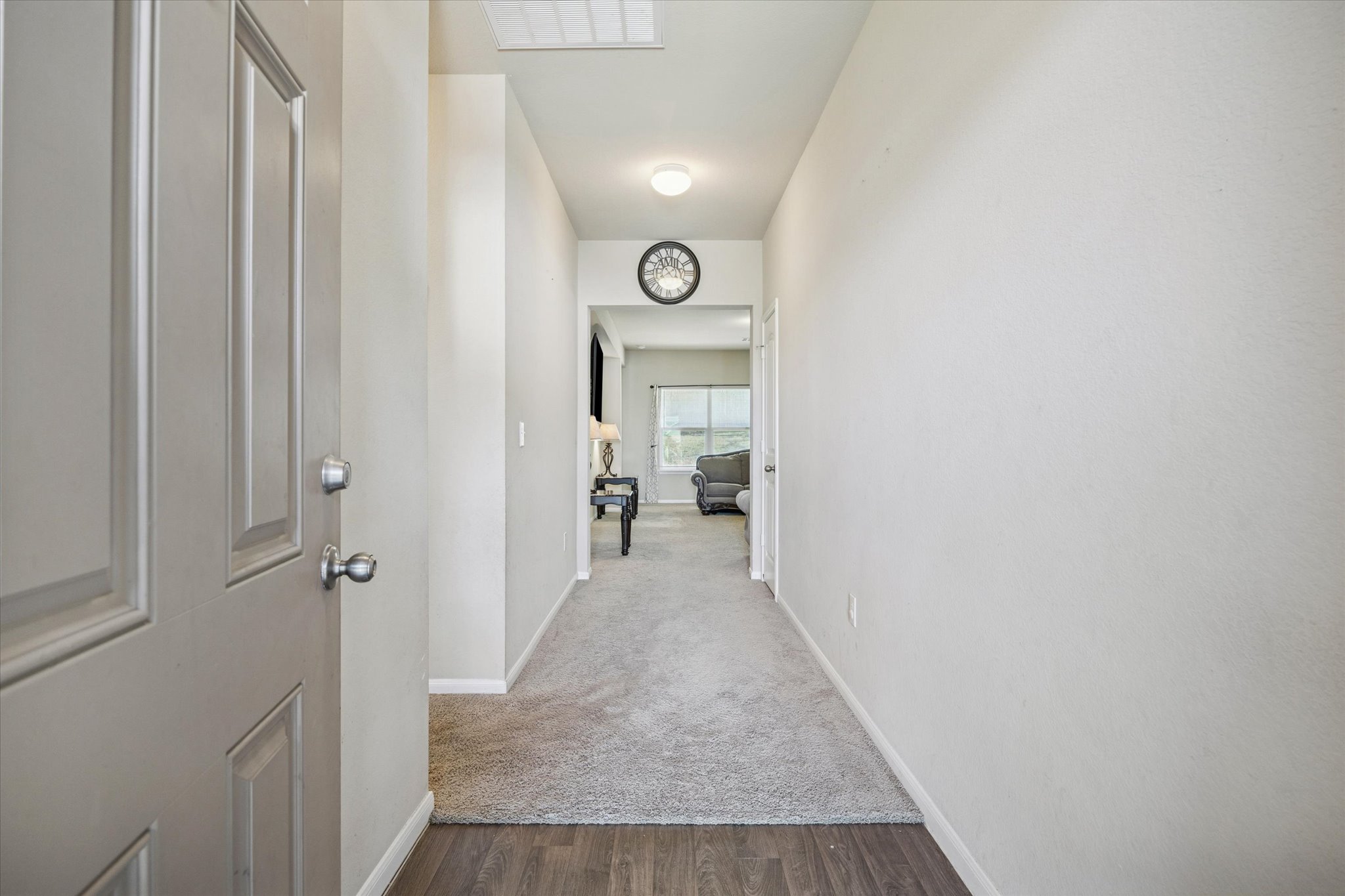 15211 Wideleaf Cove Austin, TX 78724 - Photo 2 of 15 a view of a hallway with wooden floor and a bathroom