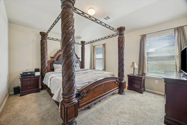 a bedroom with a bed window and balcony