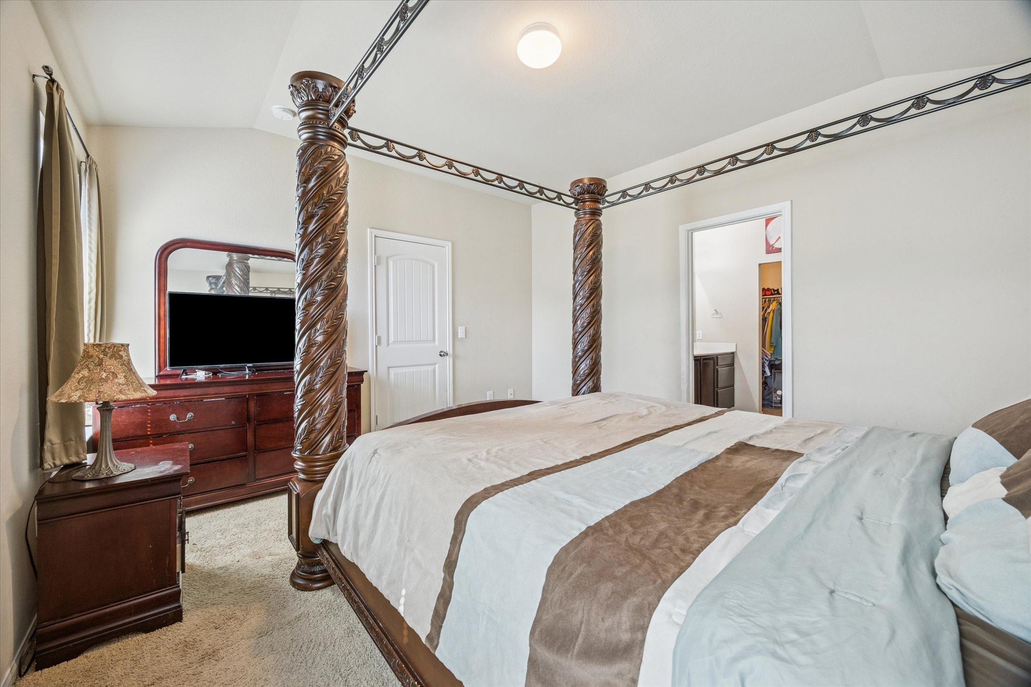 15211 Wideleaf Cove Austin, TX 78724 - Photo 10 of 15 a bedroom with a bed and a flat screen tv