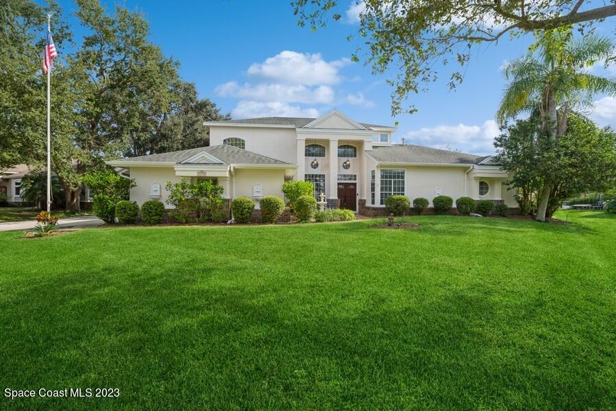 4395 Canard Road Melbourne, FL 32934 - Photo 1 of 36 a front view of a house with a garden and trees