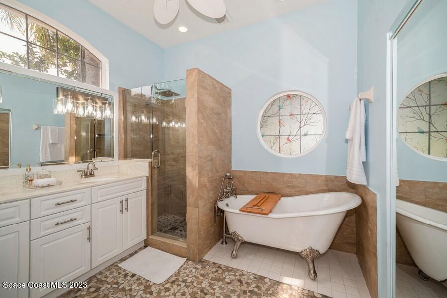 4395 Canard Road Melbourne, FL 32934 - Photo 17 of 36 a spacious bathroom with a tub sink and mirror