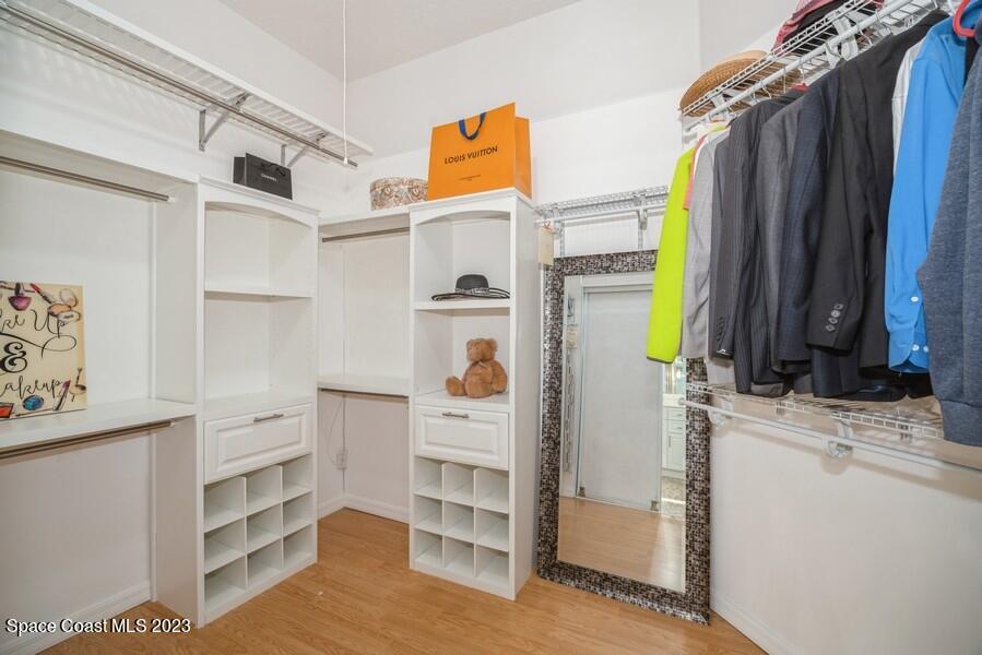 4395 Canard Road Melbourne, FL 32934 - Photo 19 of 36 a view of walk in closet with clothes and shoes
