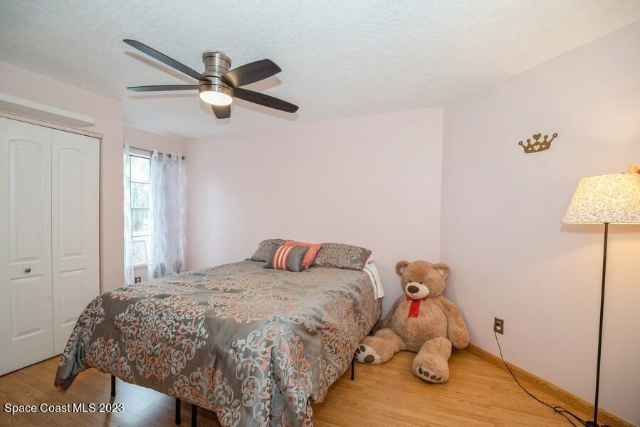 4395 Canard Road Melbourne, FL 32934 - Photo 23 of 36 a bedroom with a bed and a chandelier