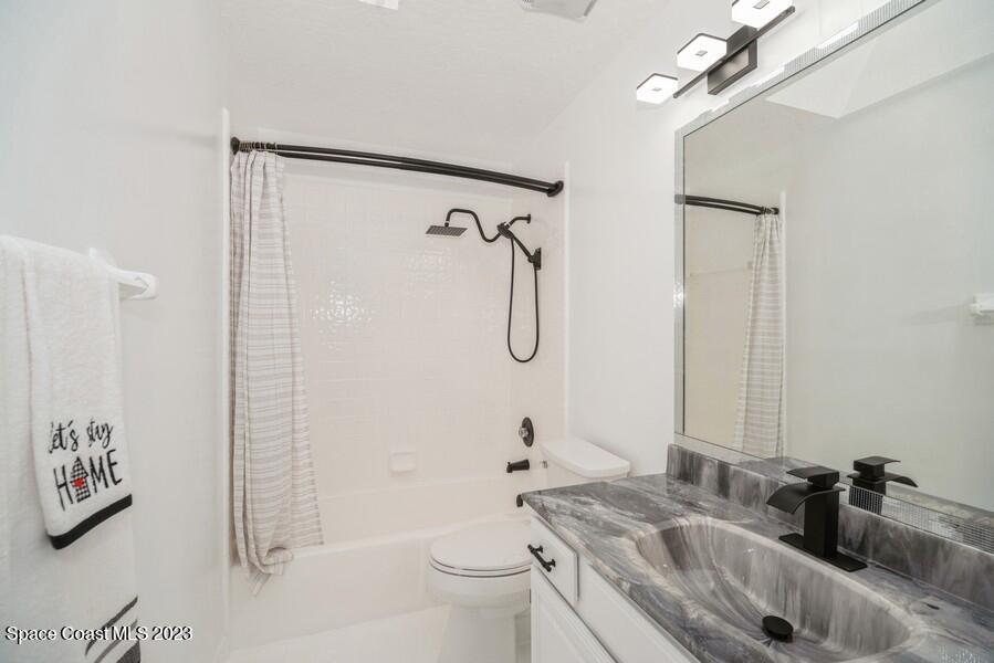 4395 Canard Road Melbourne, FL 32934 - Photo 25 of 36 a bathroom with a sink a toilet and shower