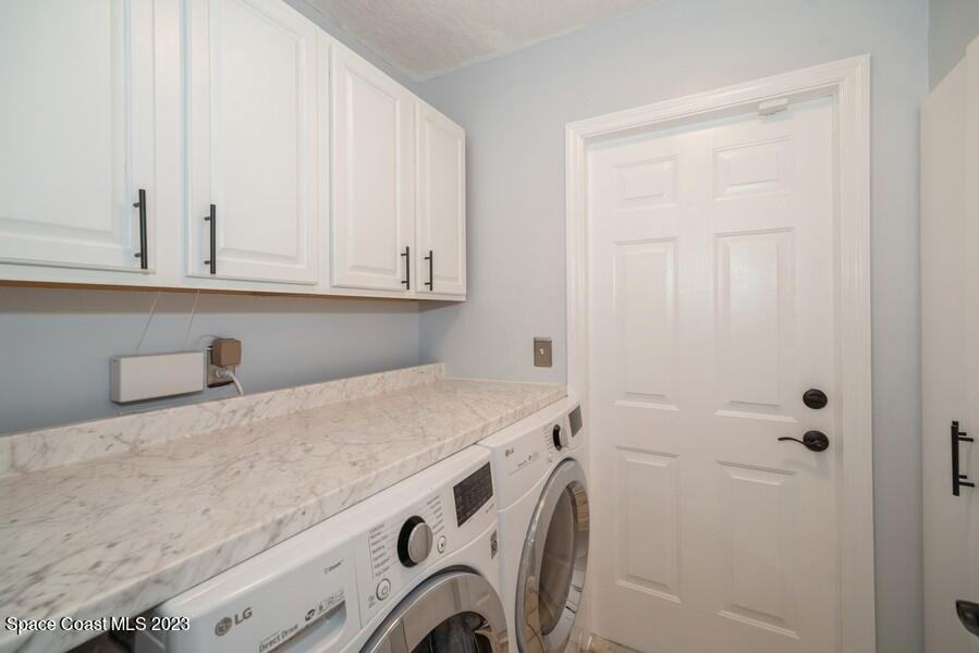 4395 Canard Road Melbourne, FL 32934 - Photo 26 of 36 a utility room with dryer and washer