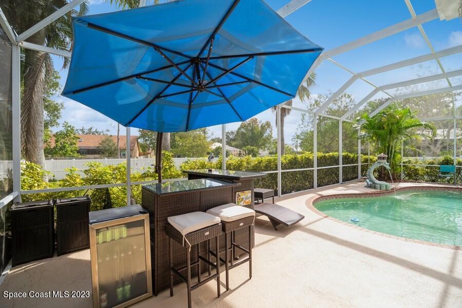 4395 Canard Road Melbourne, FL 32934 - Photo 27 of 36 a view of a chairs and table under an umbrella