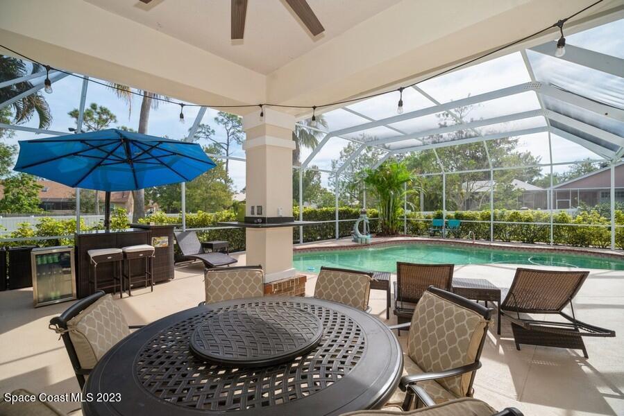 4395 Canard Road Melbourne, FL 32934 - Photo 28 of 36 a view of a patio with couches chairs and umbrella