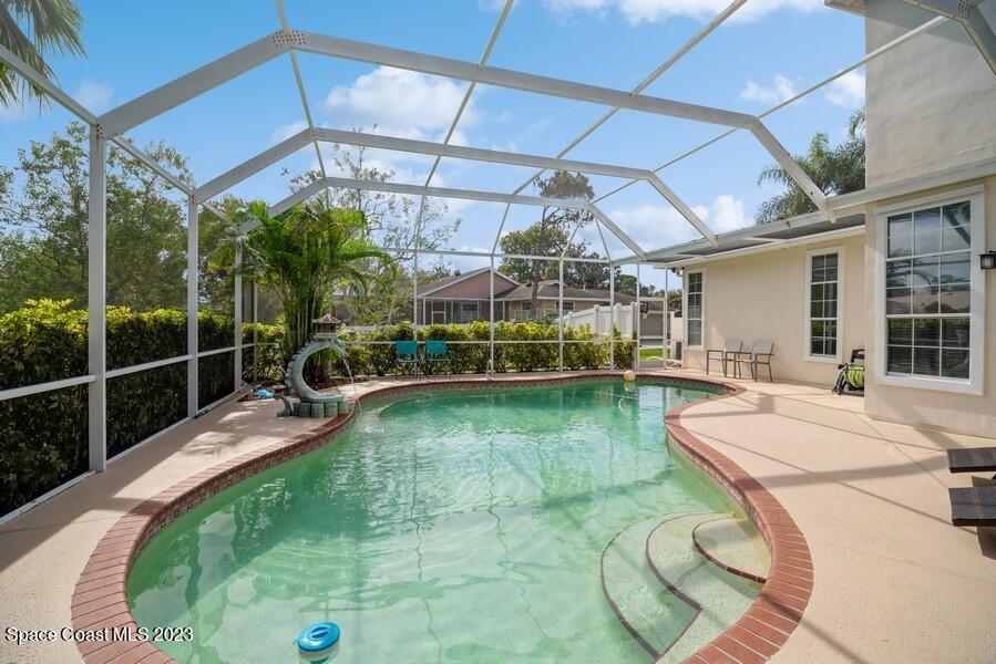 4395 Canard Road Melbourne, FL 32934 - Photo 29 of 36 a view of a swimming pool with a patio