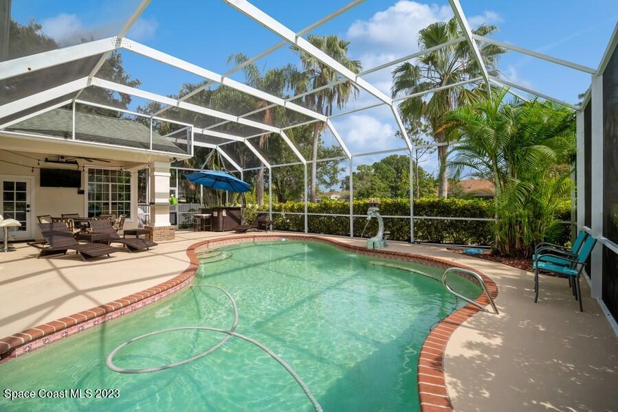 4395 Canard Road Melbourne, FL 32934 - Photo 30 of 36 a view of a backyard with table and chairs potted plants
