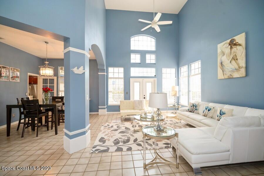 4395 Canard Road Melbourne, FL 32934 - Photo 6 of 36 a living room with furniture a dining table and large windows