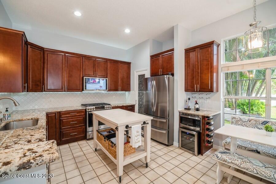 4395 Canard Road Melbourne, FL 32934 - Photo 8 of 36 a kitchen with stainless steel appliances a stove a sink and a refrigerator