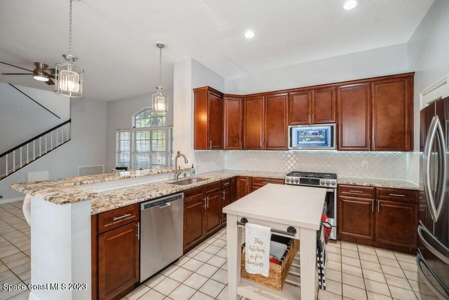 4395 Canard Road Melbourne, FL 32934 - Photo 9 of 36 a kitchen that has a sink a stove and chairs