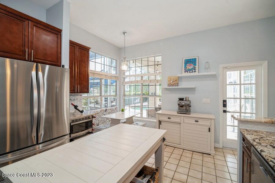 4395 Canard Road Melbourne, FL 32934 - Photo 10 of 36 a kitchen that has a lot of cabinets in it and wooden floors