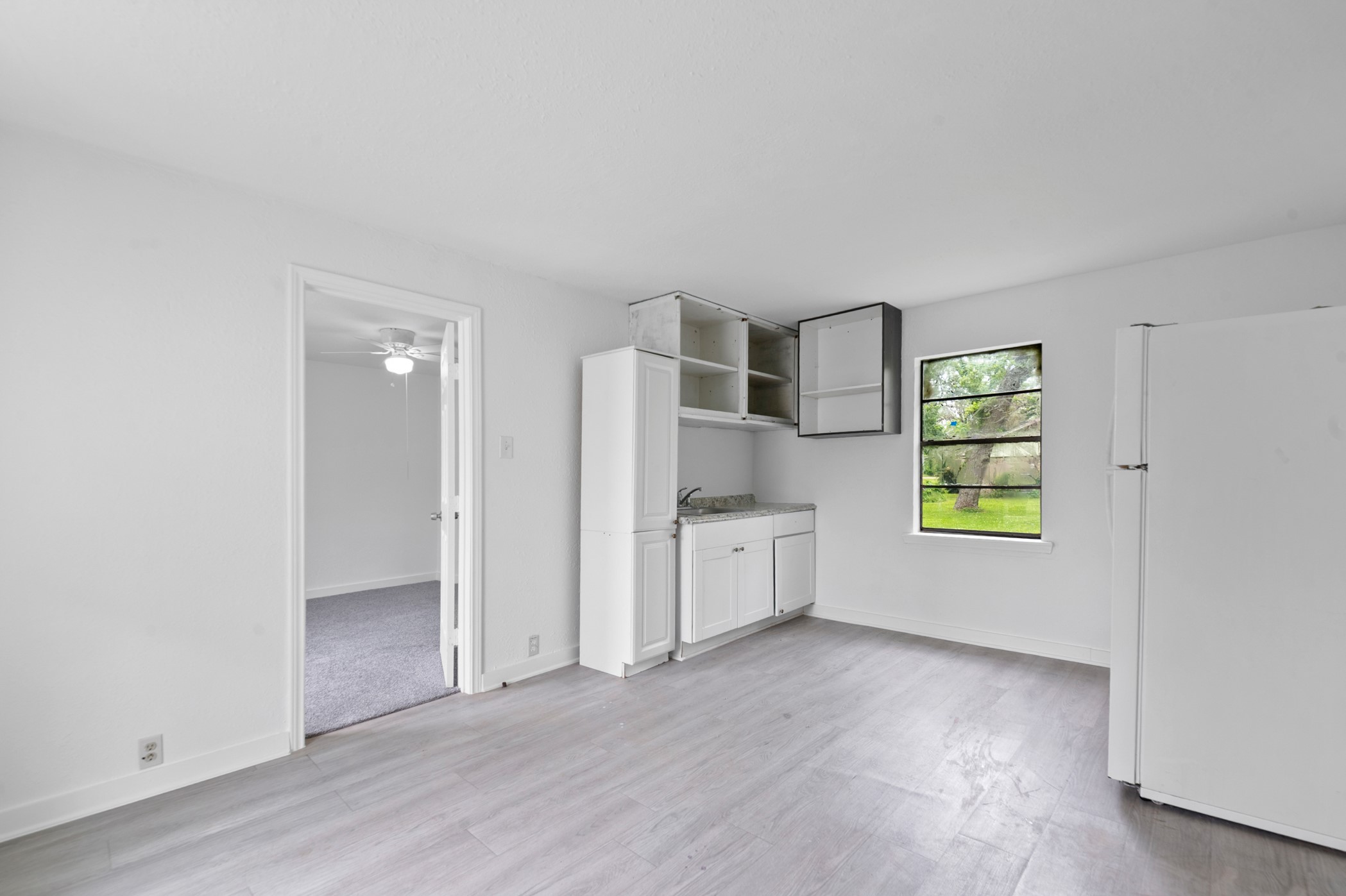 806 East Emily Avenue, Unit 1 Wharton, TX 77488 - Photo 1 of 32 a view of an empty room with window and wooden floor