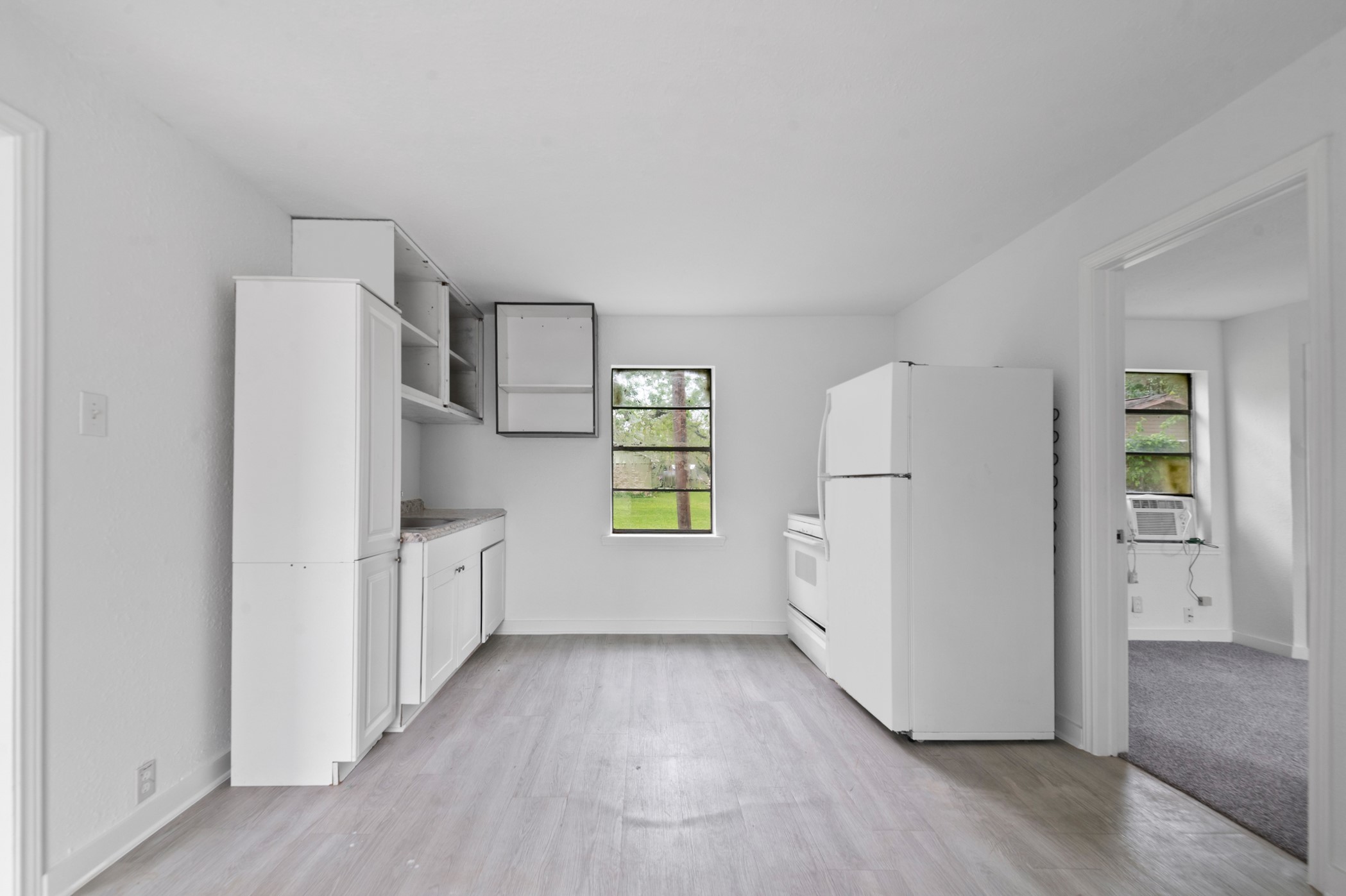 806 East Emily Avenue, Unit 1 Wharton, TX 77488 - Photo 2 of 32 a kitchen with white cabinets and white appliances