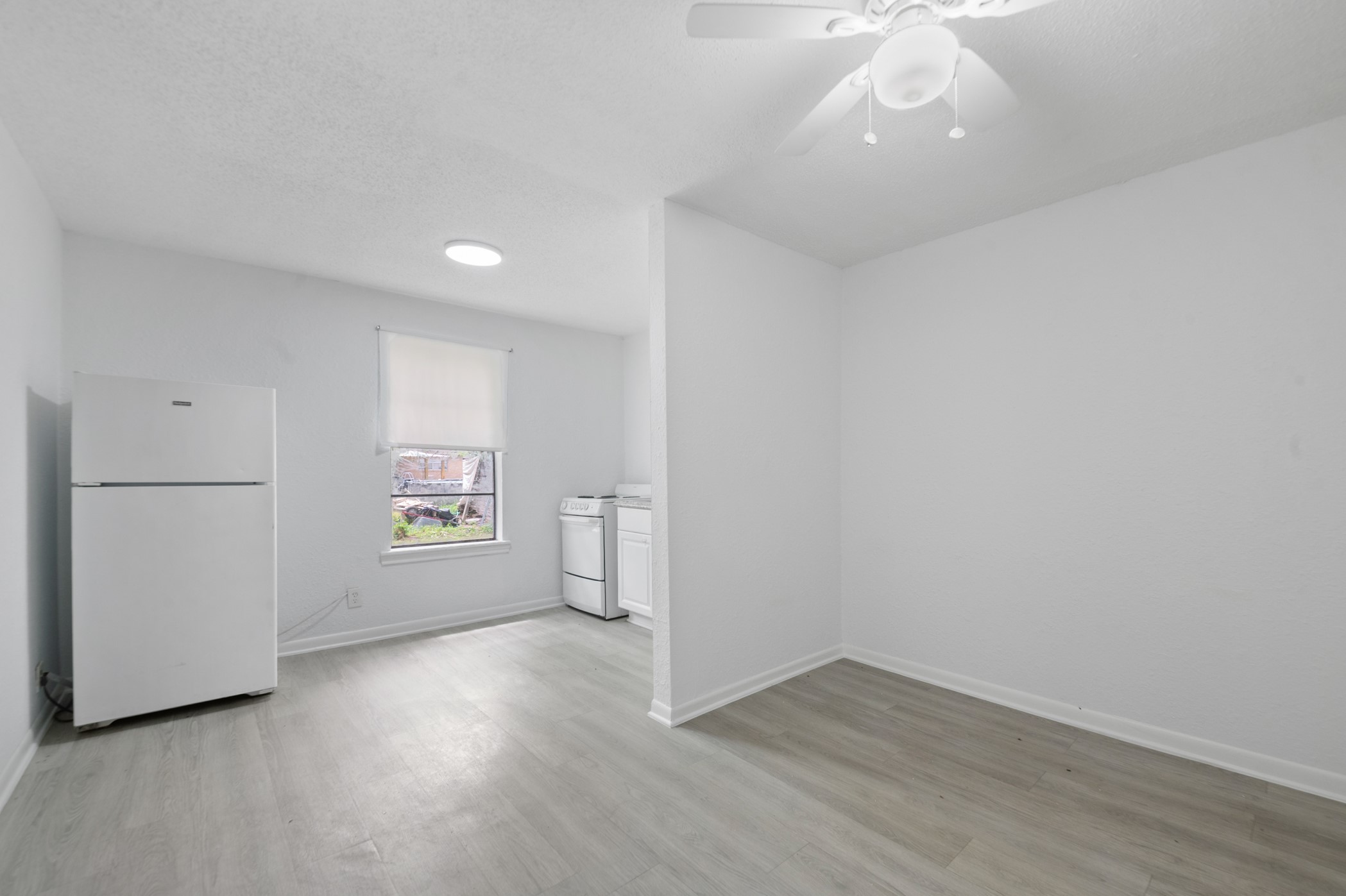 806 East Emily Avenue, Unit 1 Wharton, TX 77488 - Photo 21 of 32 an empty room with wooden floor and windows