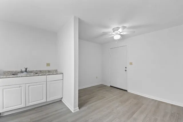 a bathroom with a granite countertop sink vanity and a