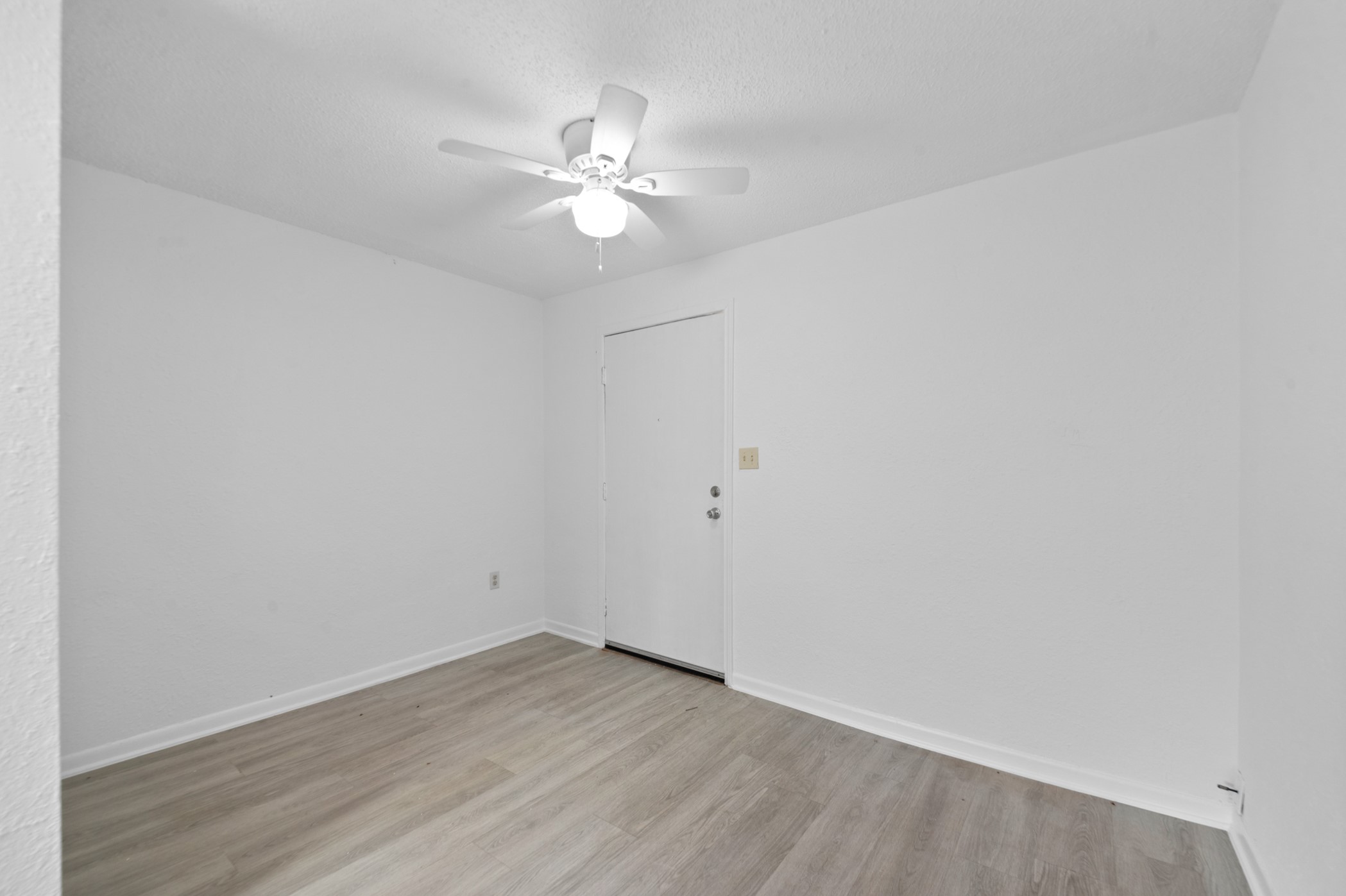 806 East Emily Avenue, Unit 1 Wharton, TX 77488 - Photo 27 of 32 a view of an empty room with wooden floor