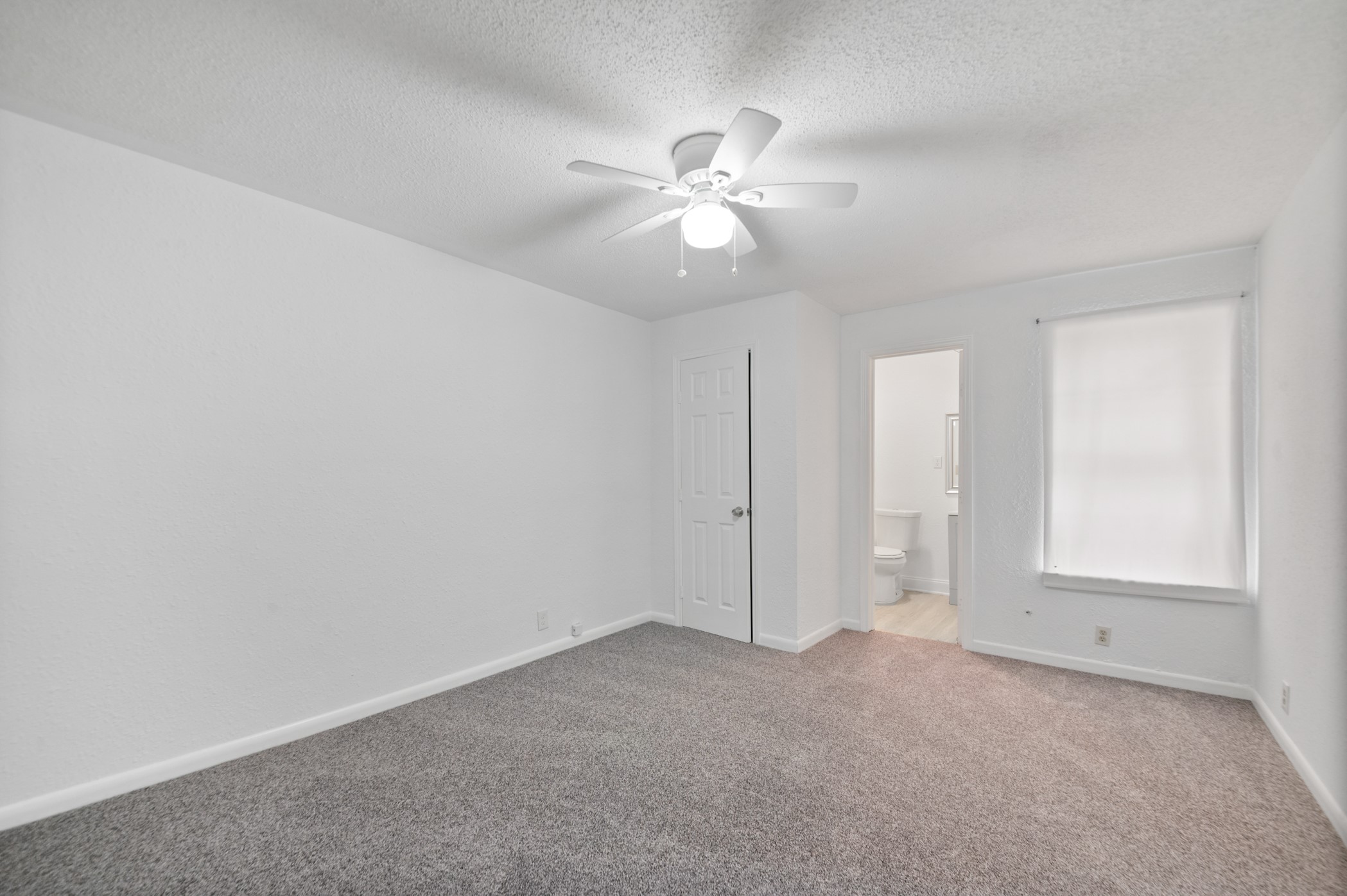 806 East Emily Avenue, Unit 1 Wharton, TX 77488 - Photo 28 of 32 an empty room with closet and a chandelier fan