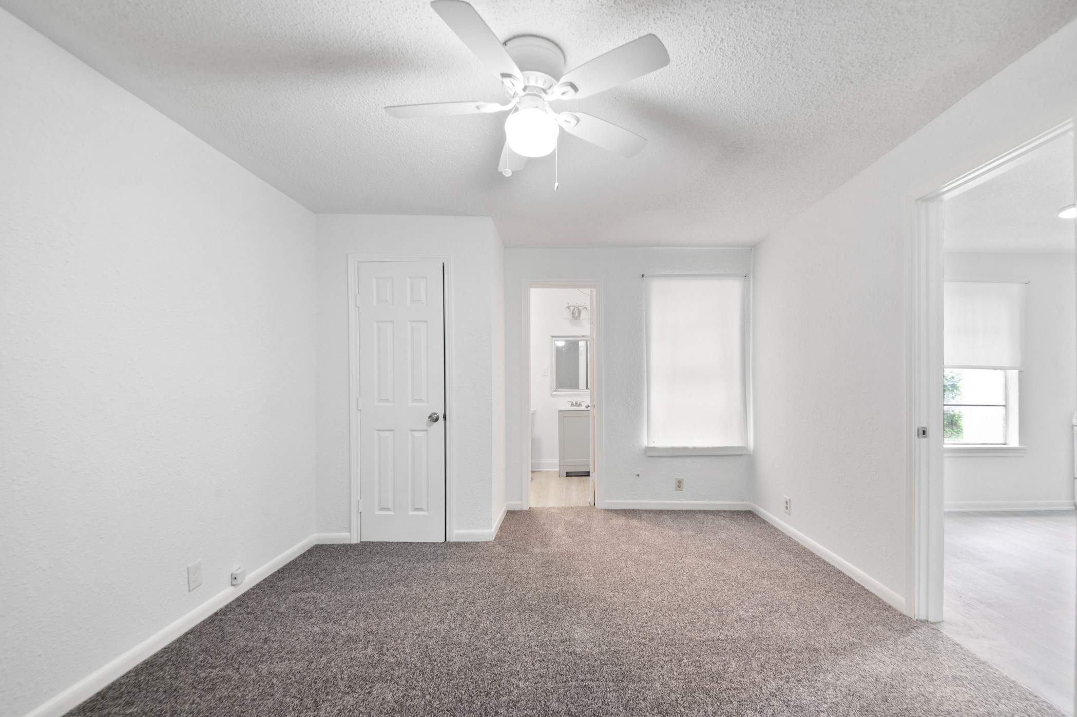 806 East Emily Avenue, Unit 1 Wharton, TX 77488 - Photo 29 of 32 an empty room with chandelier fan and windows
