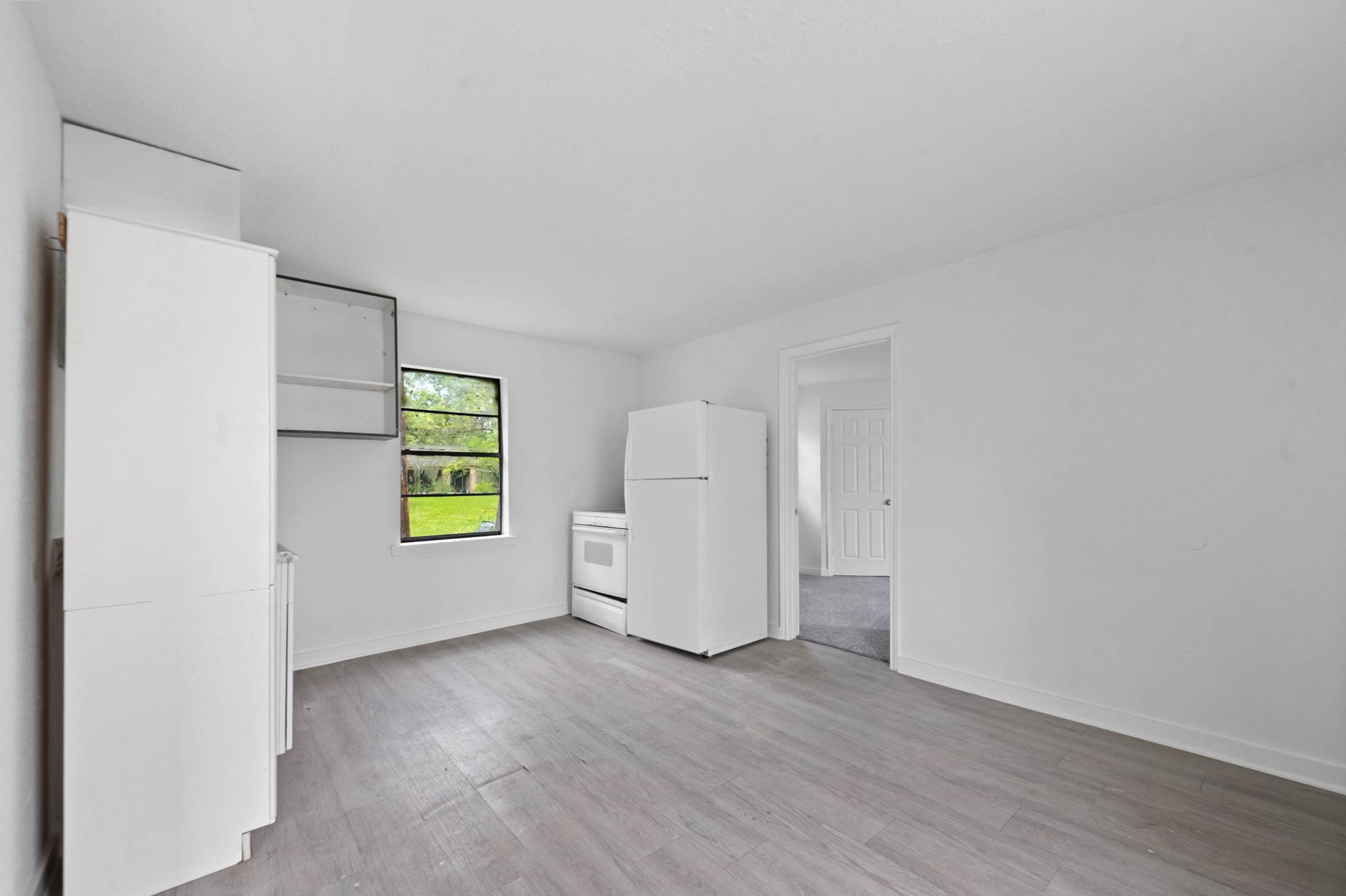 806 East Emily Avenue, Unit 1 Wharton, TX 77488 - Photo 3 of 32 an empty room with windows and cabinet
