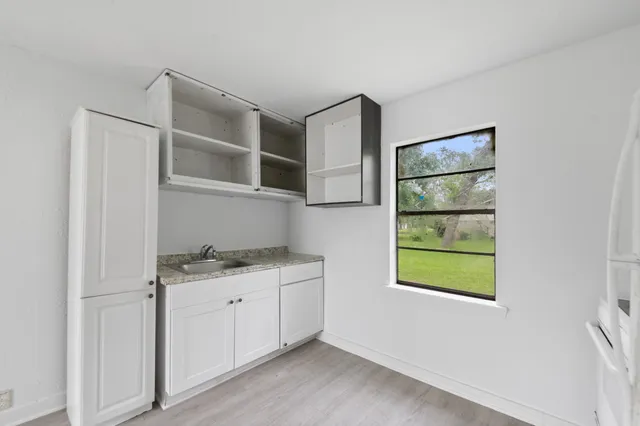 a kitchen with a cabinets and window
