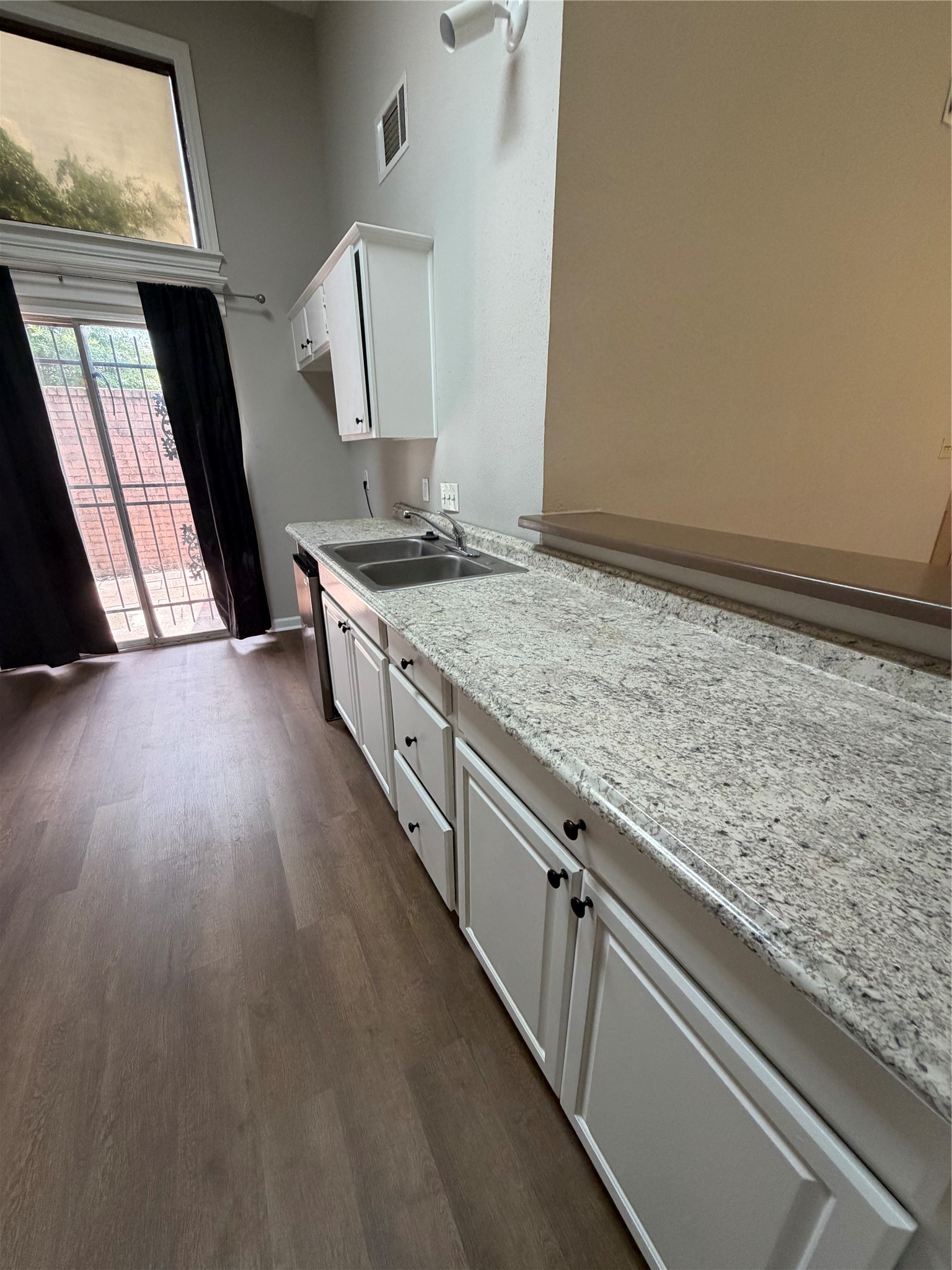 8662 Pearl Point Street Houston, TX 77044 - Photo 6 of 28 a kitchen with sink stove and cabinets