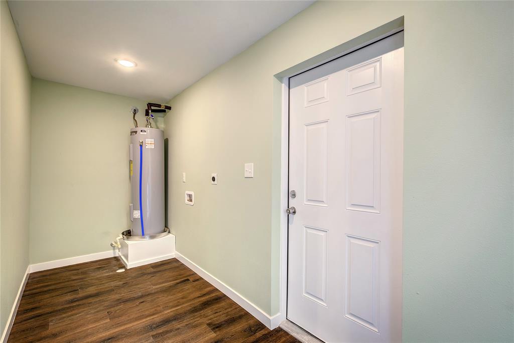 520 North 1st Street Point, TX 75472 - Photo 27 of 34 a view of an empty room with wooden floor and a bathroom