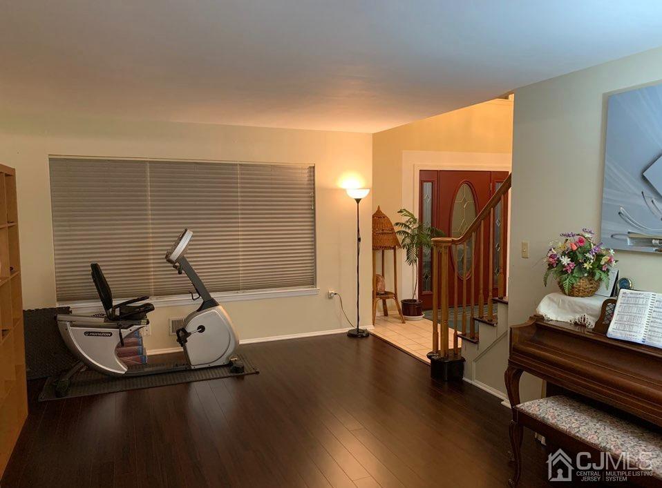 41 Amboy Road Old Bridge, NJ 07747 - Photo 4 of 20 a view of a workspace with furniture and gym equipment