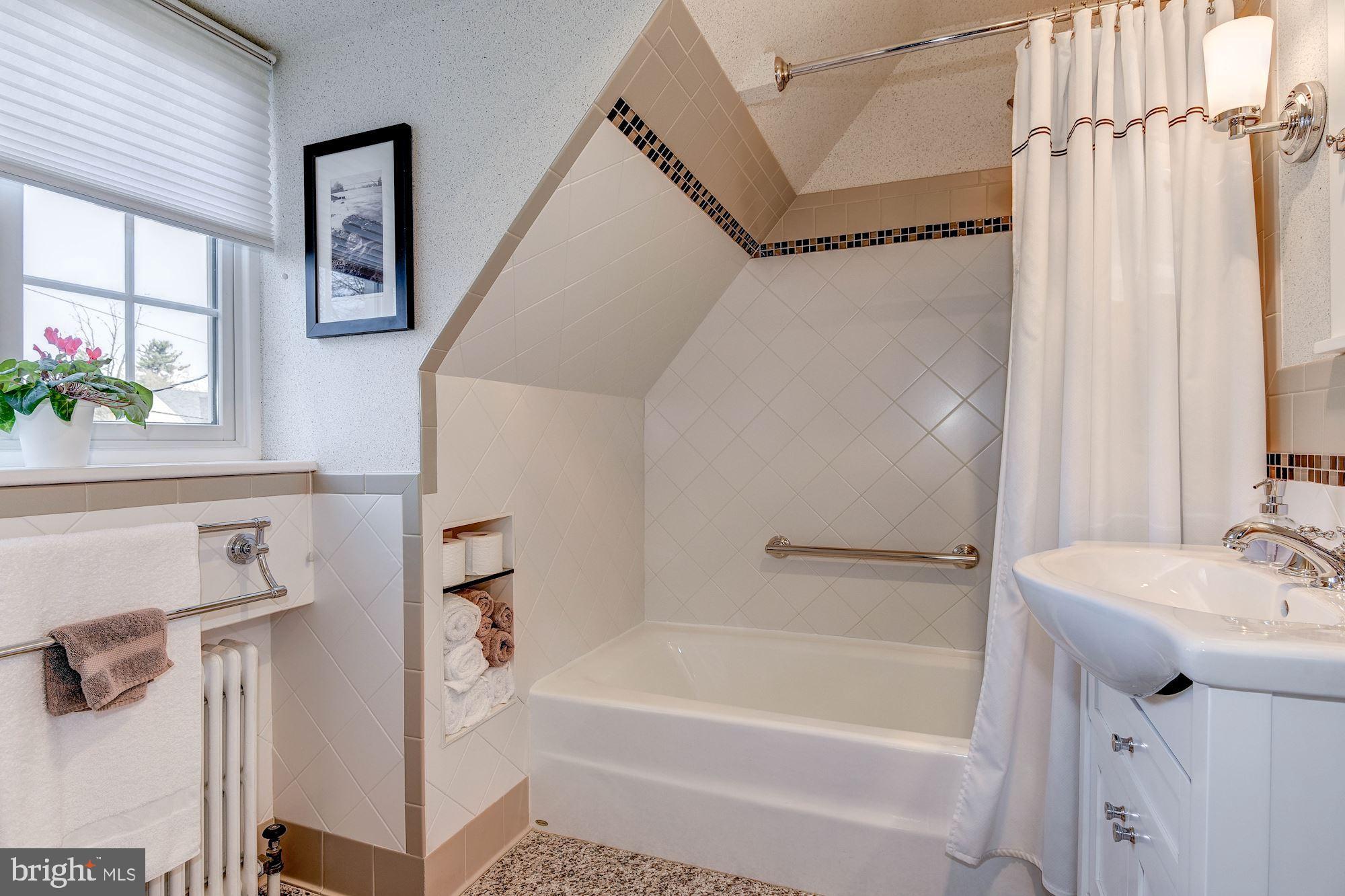 4606 Davidson Drive Chevy Chase, MD 20815 - Photo 17 of 26 a bathroom with a sink a mirror and a bathtub