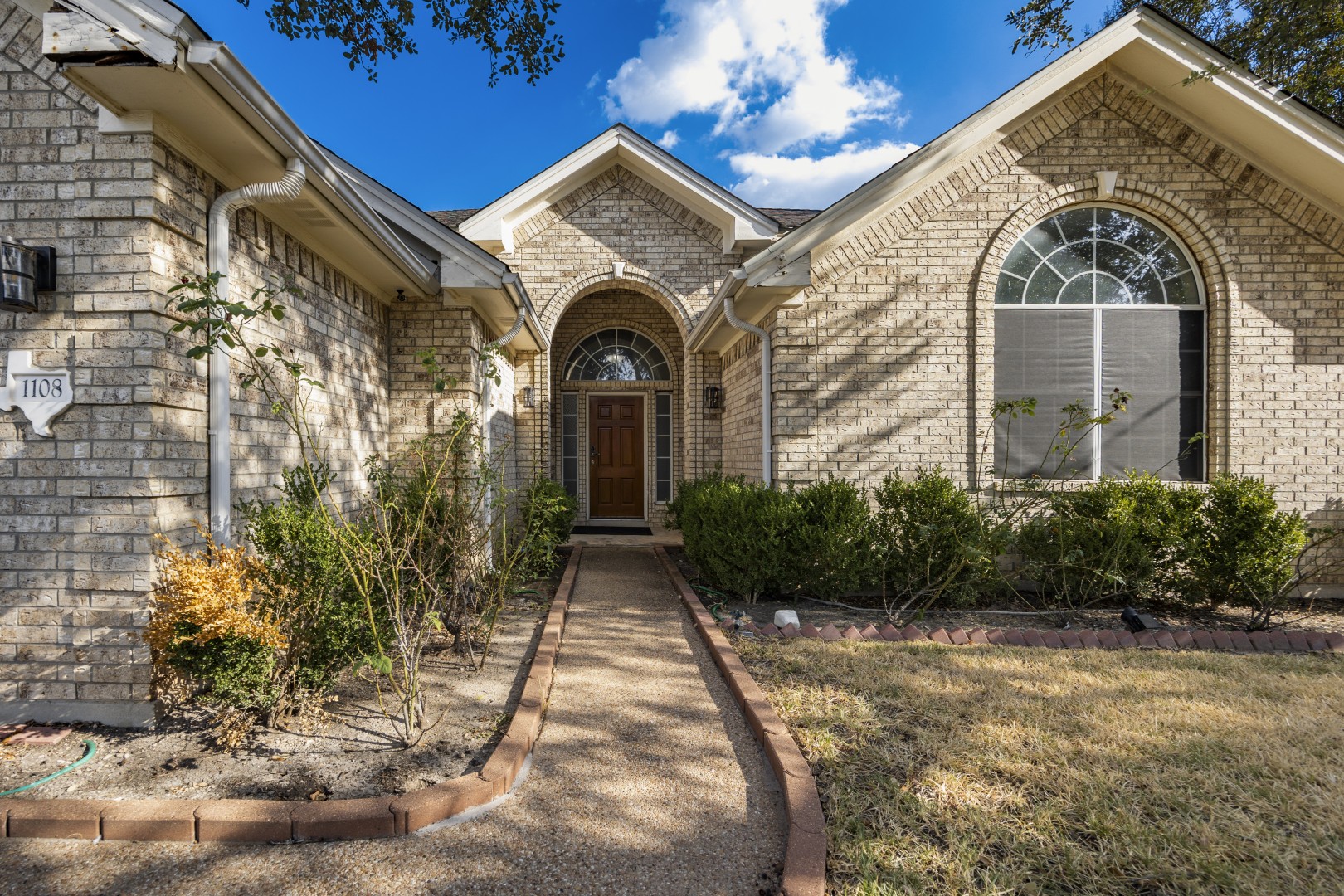 1108 Antelope Ridge Cedar Park, TX 78613 - Photo 35 of 39 An inviting stone pathway guides visitors directly to the arched recessed entryway of this home.