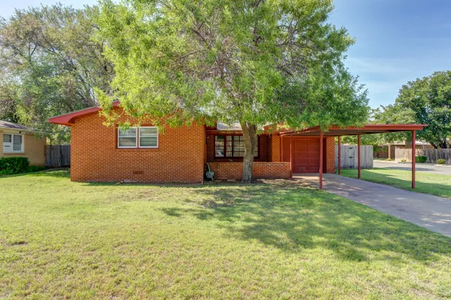 a house that has a tree in front of it