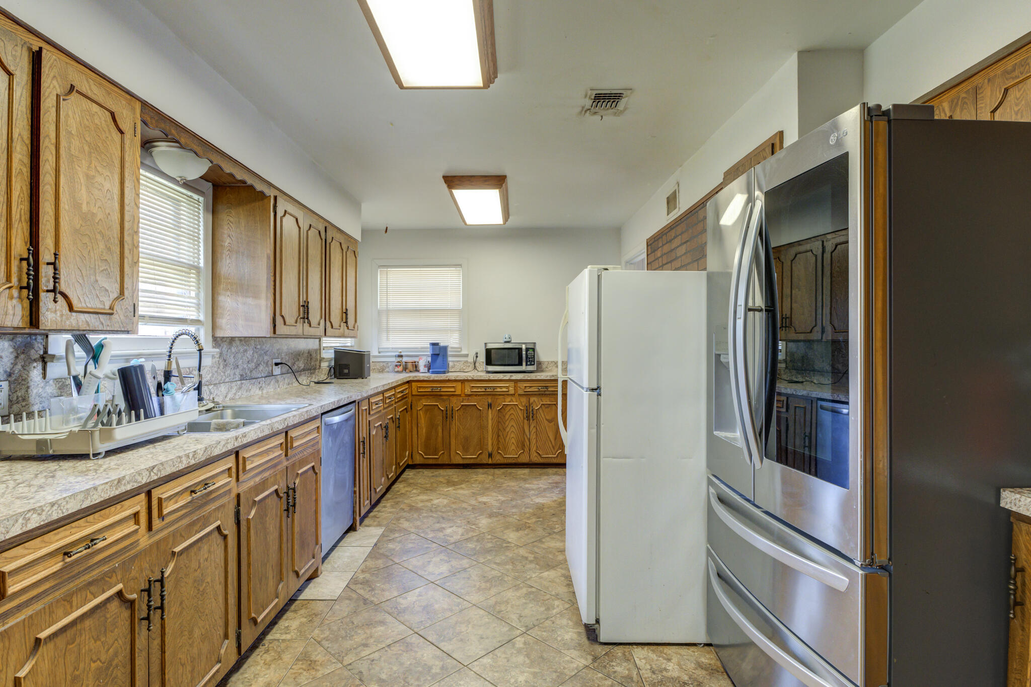 3615 37th Street Lubbock, TX 79413 - Photo 12 of 27 a kitchen with stainless steel appliances granite countertop a refrigerator and a sink