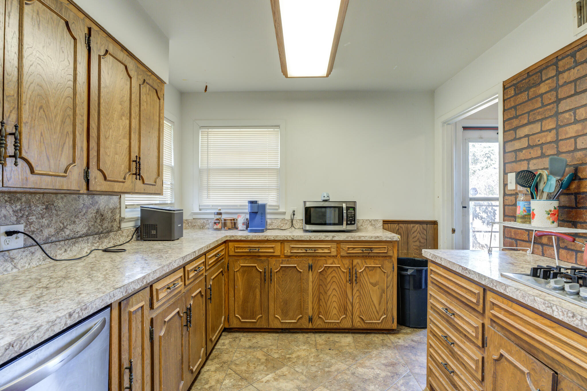 3615 37th Street Lubbock, TX 79413 - Photo 14 of 27 a kitchen with stainless steel appliances granite countertop a sink stove and refrigerator
