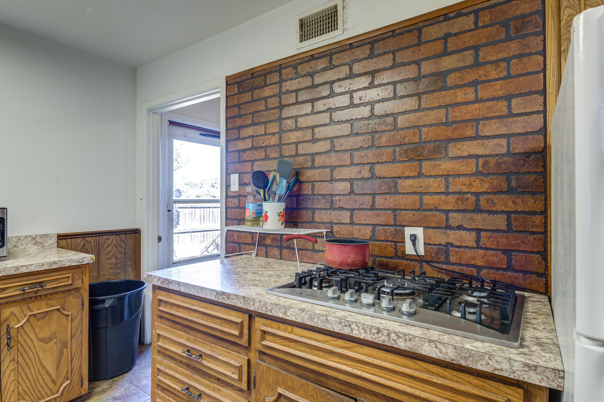 3615 37th Street Lubbock, TX 79413 - Photo 15 of 27 a dining room with a rug and a wooden floor