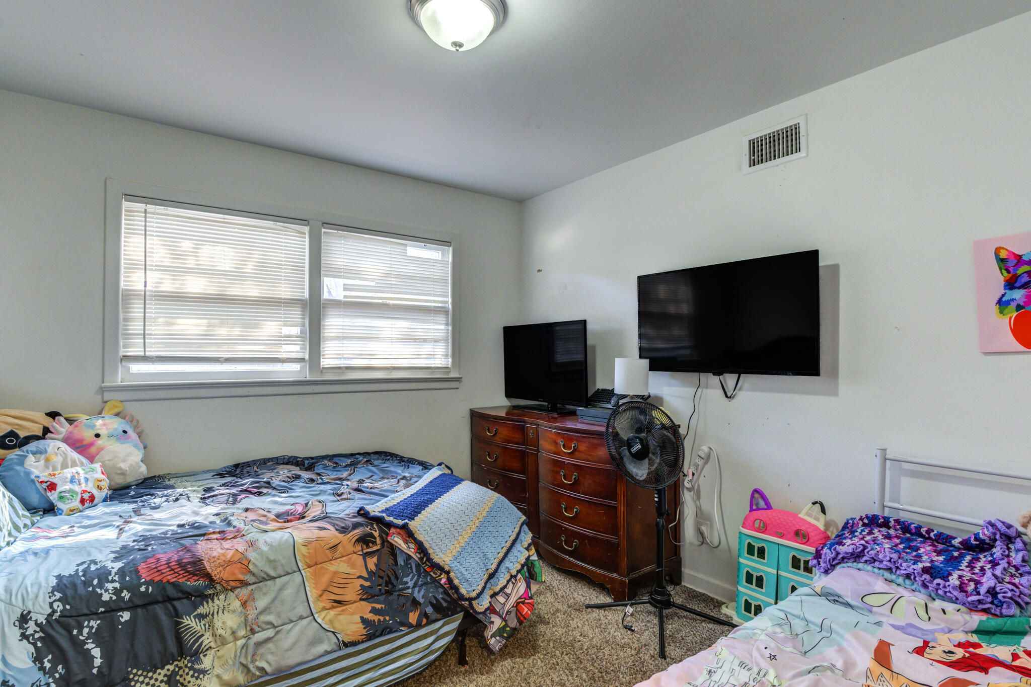 3615 37th Street Lubbock, TX 79413 - Photo 17 of 27 a bedroom with a bed and a flat screen tv