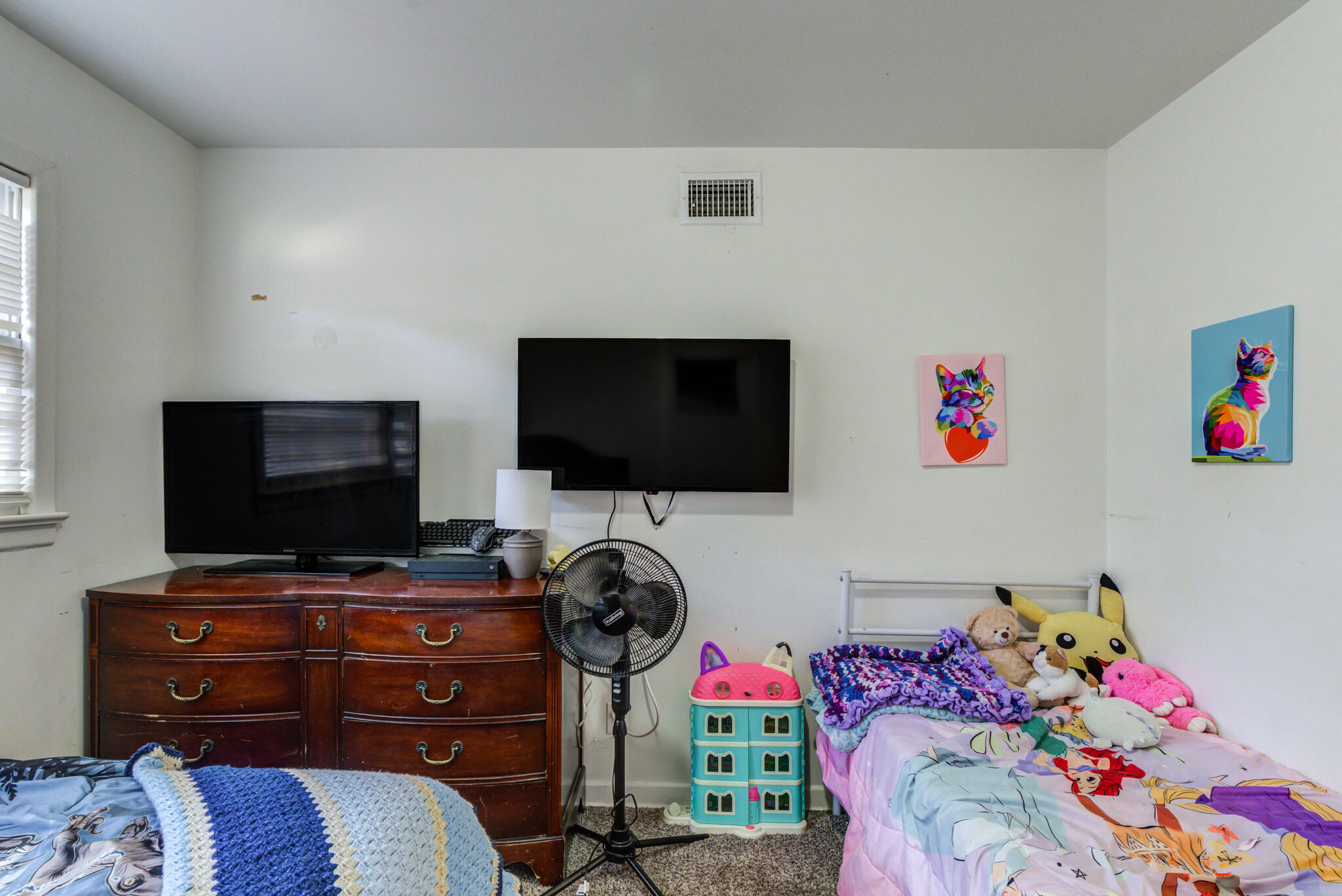 3615 37th Street Lubbock, TX 79413 - Photo 18 of 27 a bedroom with a bed and a flat screen tv