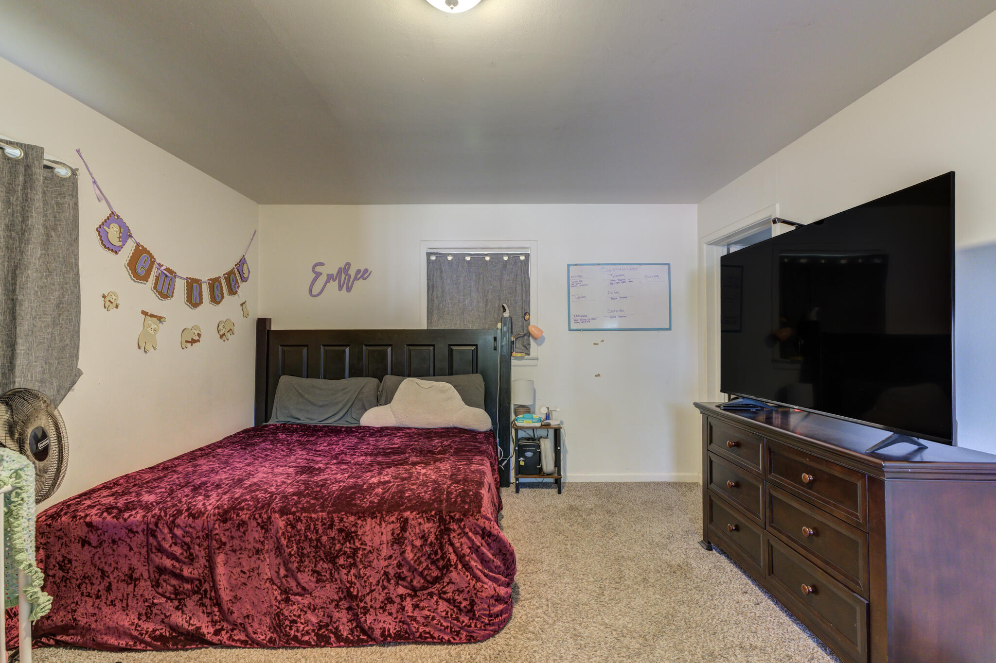 3615 37th Street Lubbock, TX 79413 - Photo 20 of 27 a bedroom with a bed and a flat screen tv