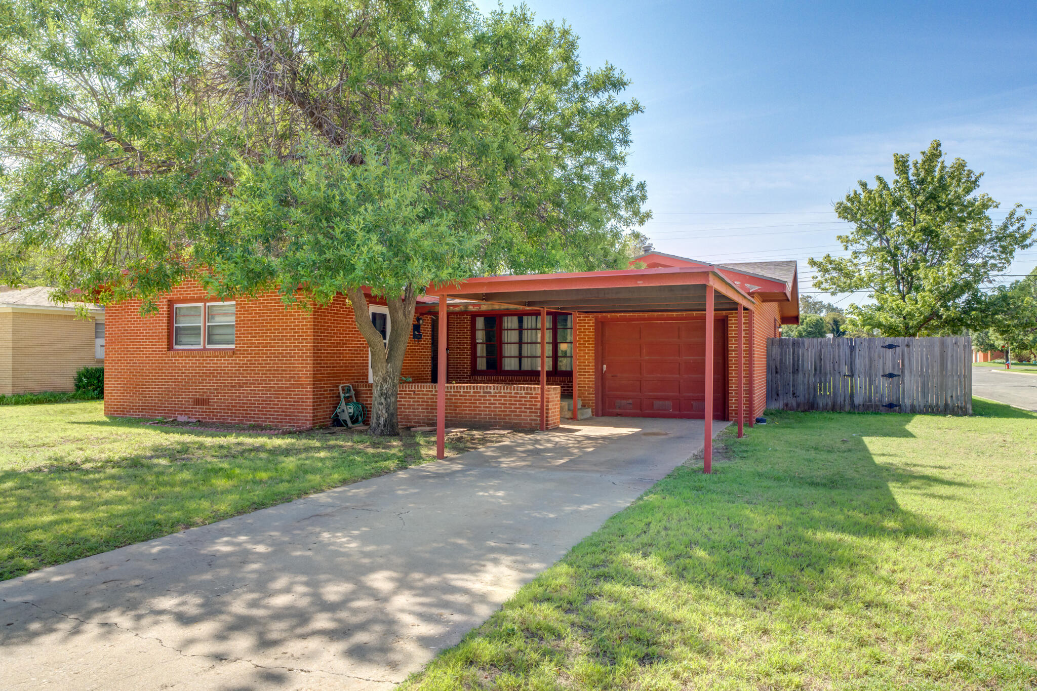 3615 37th Street Lubbock, TX 79413 - Photo 2 of 27 a front view of a house with a yard and garage