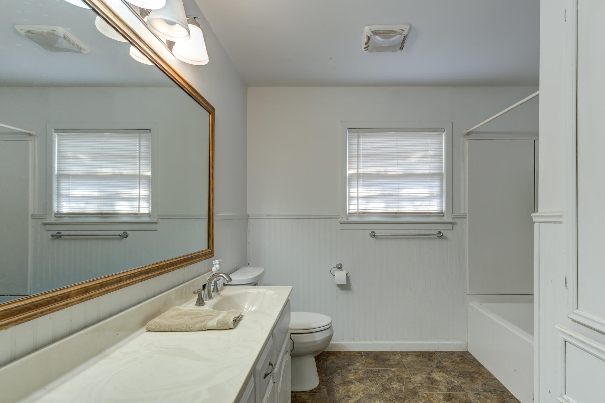 3615 37th Street Lubbock, TX 79413 - Photo 24 of 27 a bathroom with a sink a toilet and tub