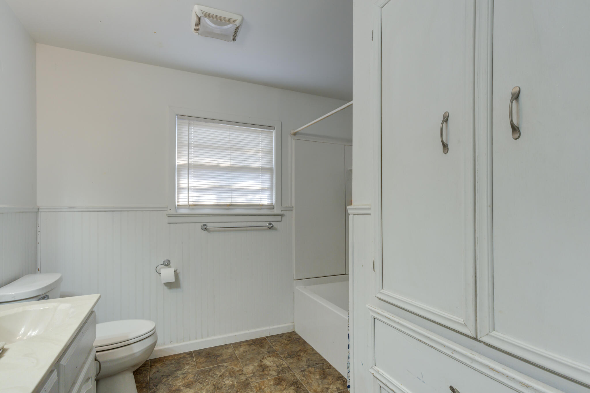 3615 37th Street Lubbock, TX 79413 - Photo 25 of 27 a bathroom with a granite countertop toilet a sink and shower
