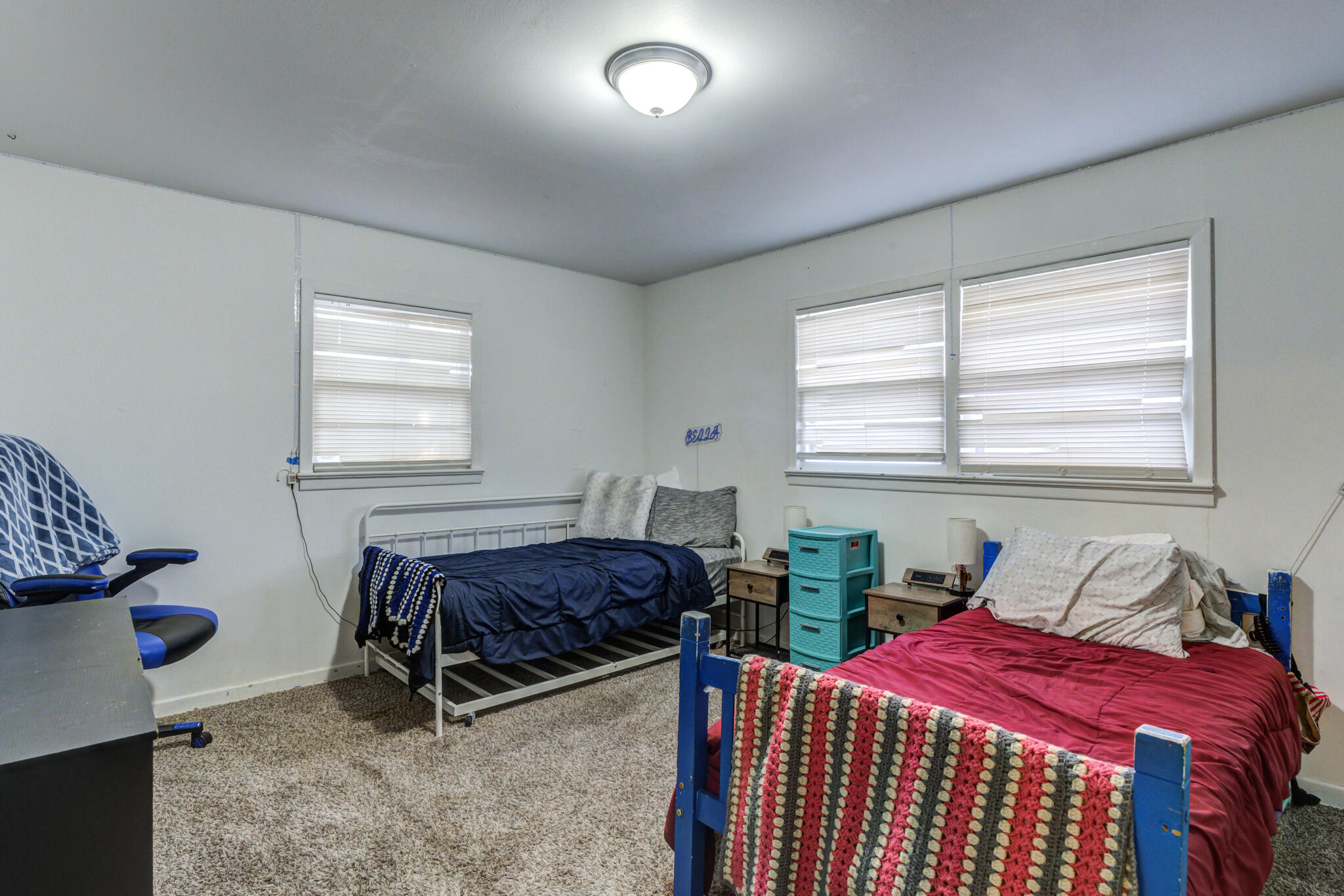3615 37th Street Lubbock, TX 79413 - Photo 26 of 27 a bedroom with two beds and a window