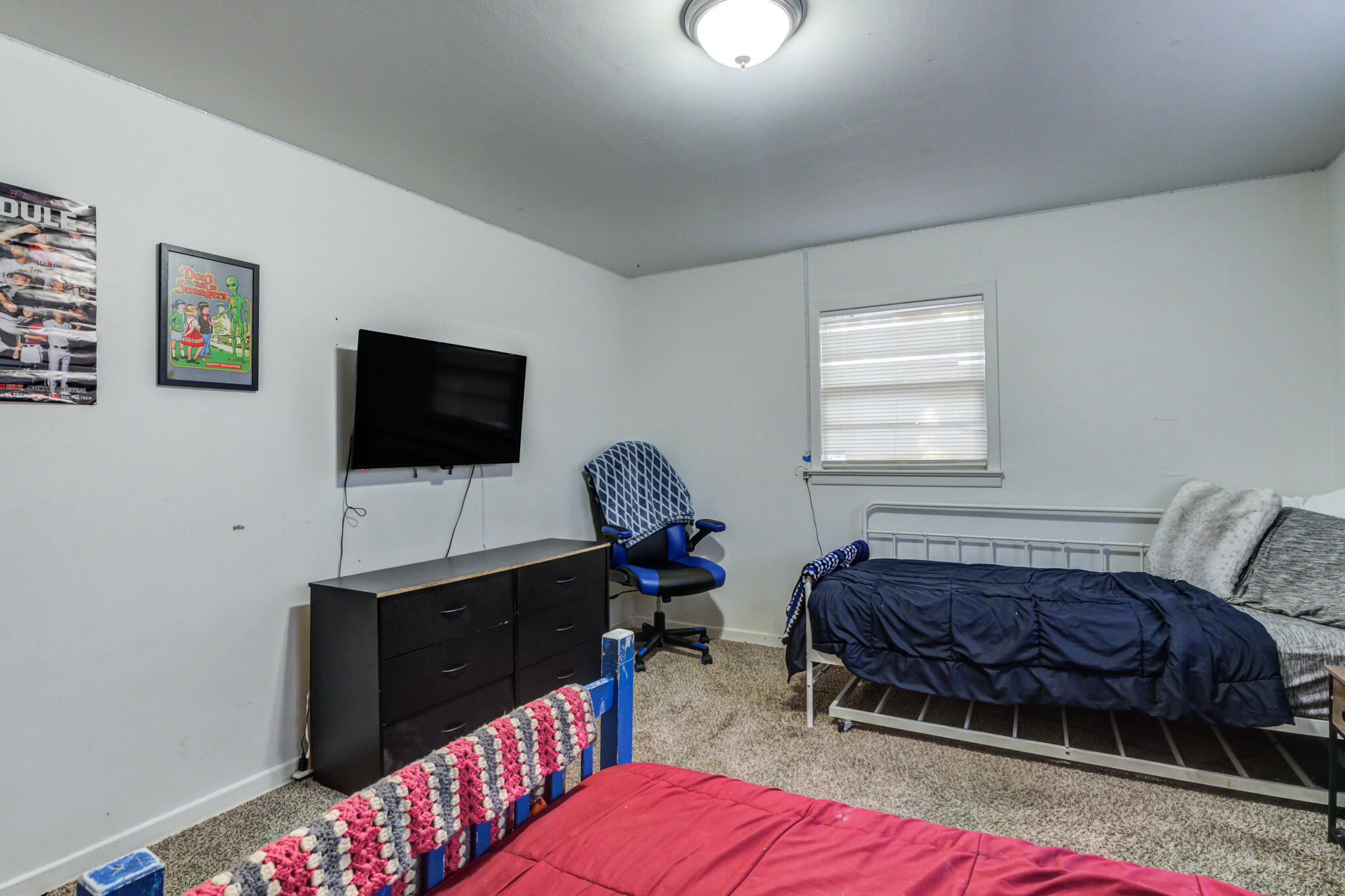 3615 37th Street Lubbock, TX 79413 - Photo 27 of 27 a bedroom with a bed and a flat screen tv
