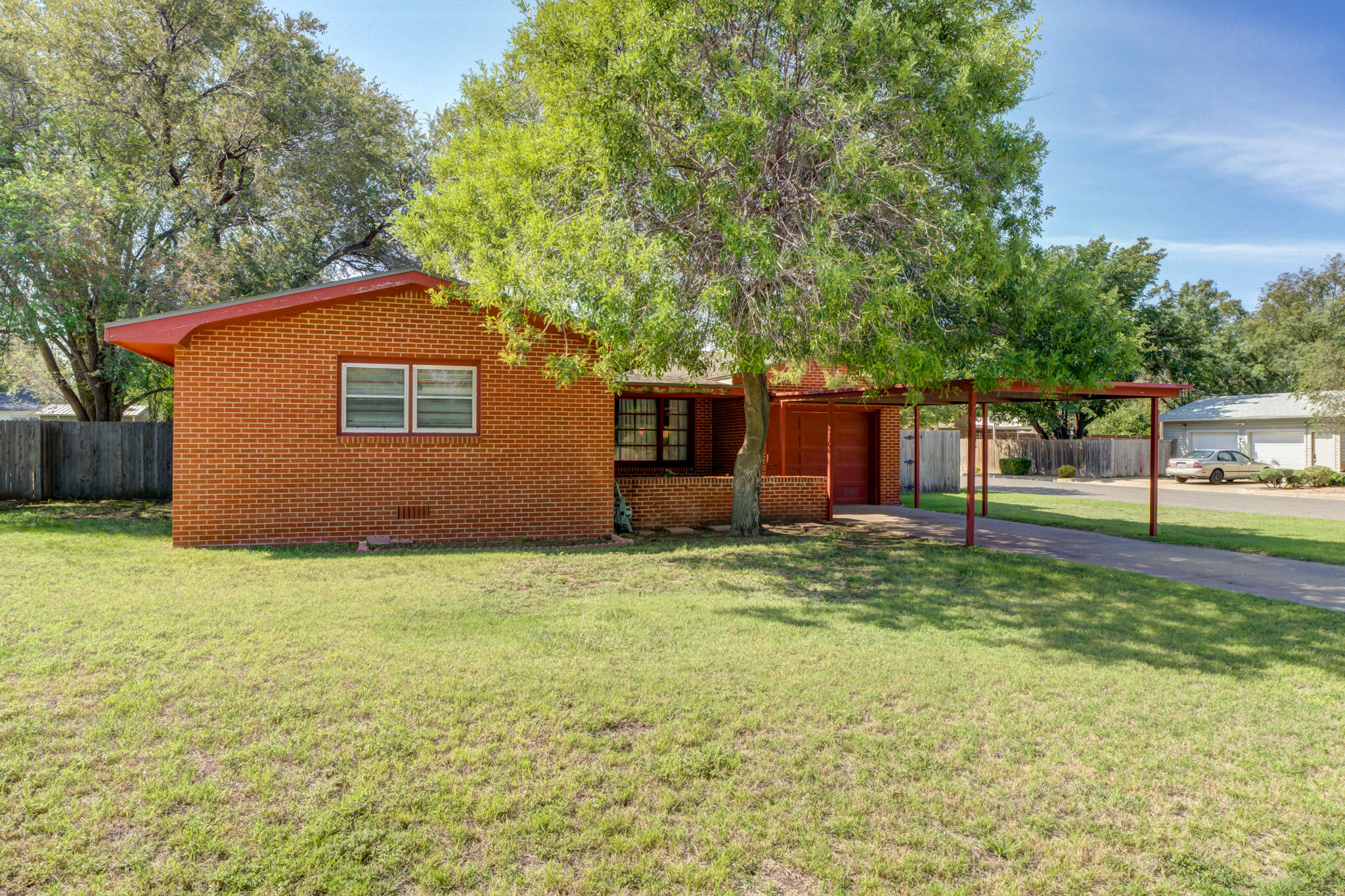 3615 37th Street Lubbock, TX 79413 - Photo 3 of 27 a house with huge green field in front of it