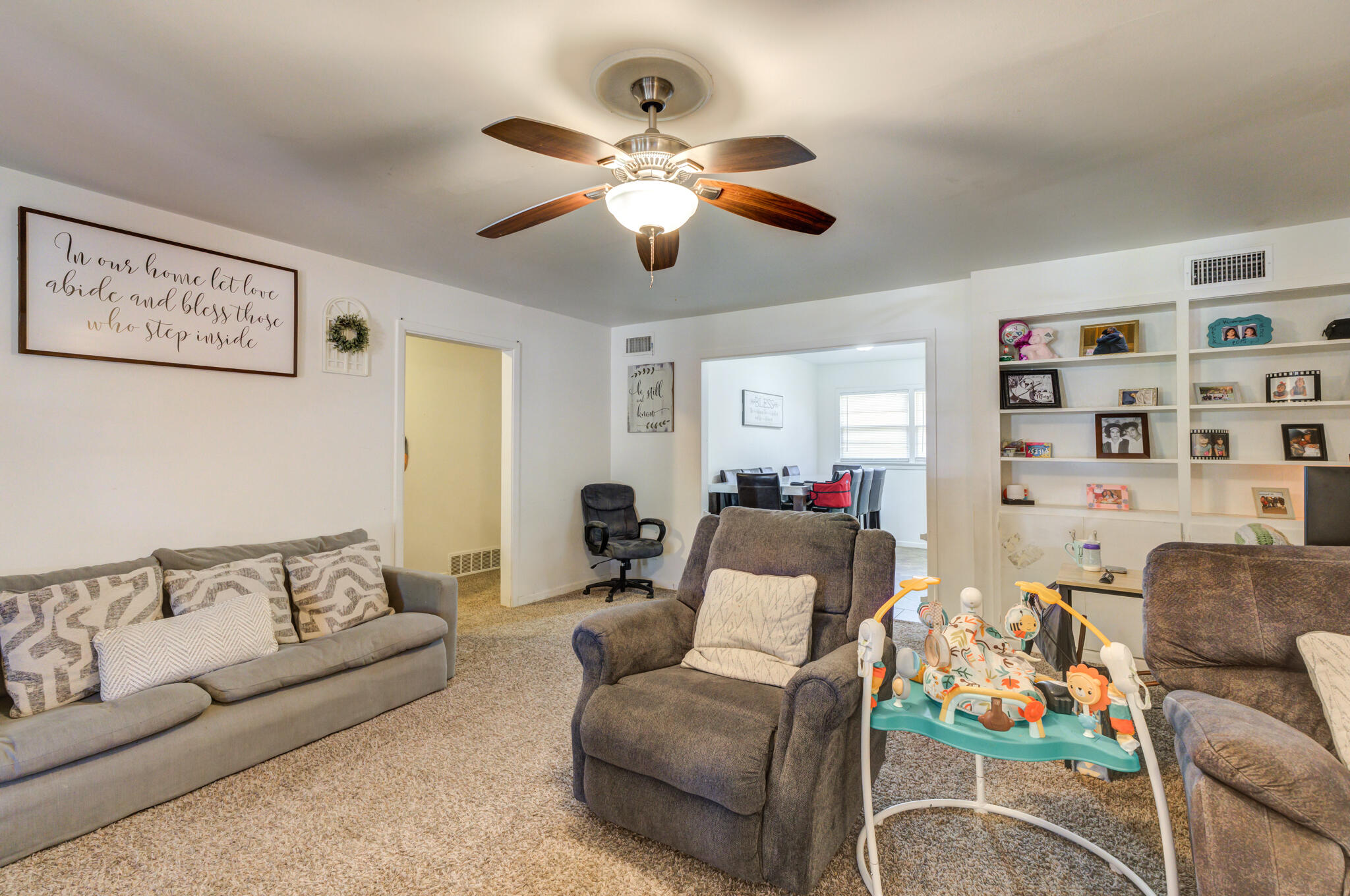 3615 37th Street Lubbock, TX 79413 - Photo 6 of 27 a living room with furniture and a chandelier