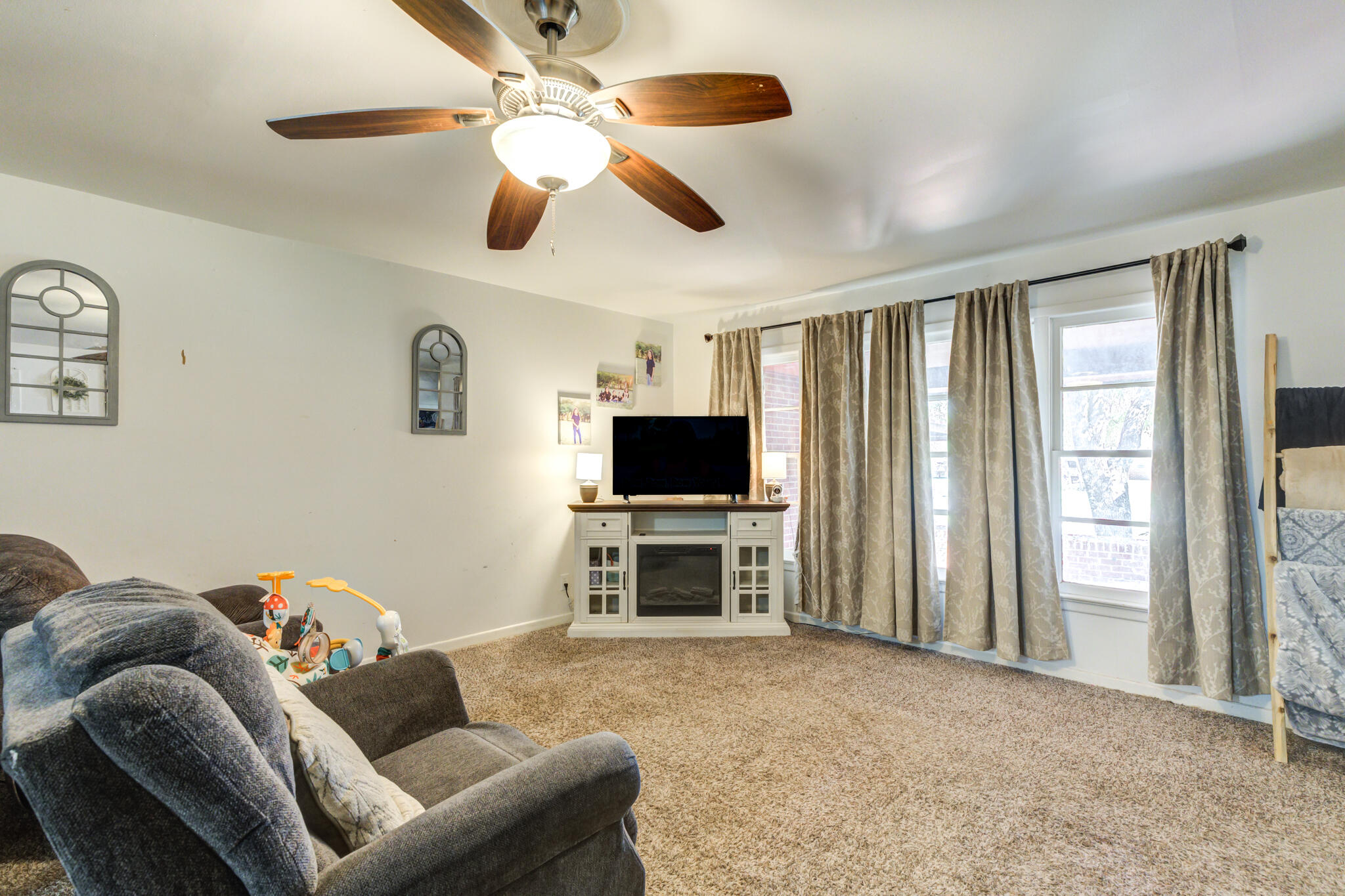 3615 37th Street Lubbock, TX 79413 - Photo 8 of 27 a living room with furniture and a flat screen tv