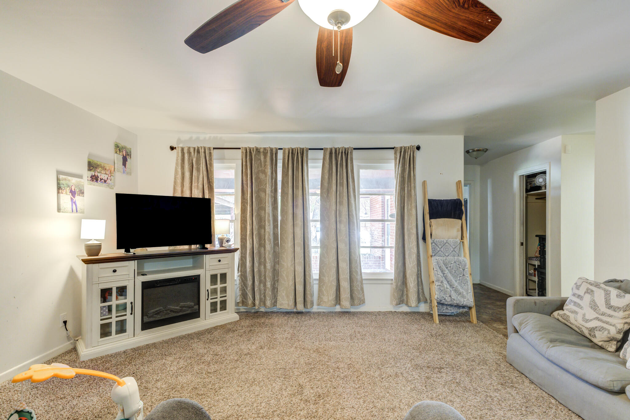 3615 37th Street Lubbock, TX 79413 - Photo 9 of 27 a living room with furniture and a flat screen tv