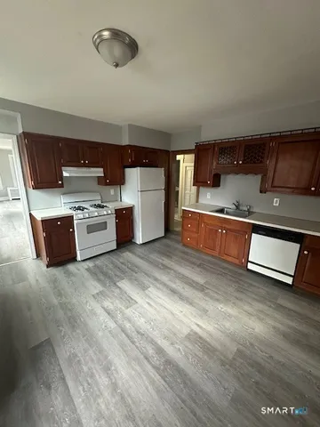 a kitchen with stainless steel appliances granite countertop a sink and cabinets